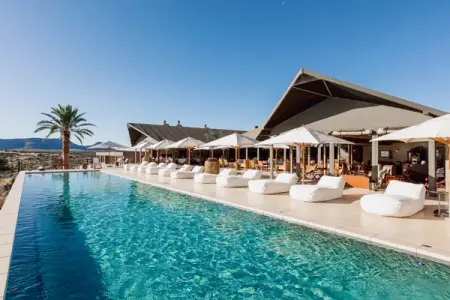 Sink into a cloud-like sun bed on the edge of the sparkling pool for a cool reprie