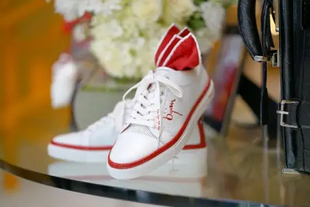 Adding casual elegance to everyday wear, the Bijan Red sneakers feature perfora