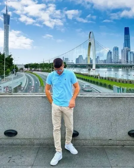 A clear blue sky, a magnificent bridge, and towering buildings in the dista